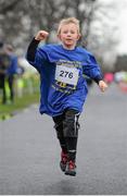 1 January 2014; Cian O'Toole, aged 10, from Crumlin, Dublin, in action during the 2014 Tom Brennan Memorial Trophy 5K Road Race. Phoenix Park, Dublin. Picture credit: Tomás Greally / SPORTSFILE