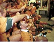 6 November 1999; The Australian team celebrate with the Webb Ellis trophy in the dressing room after their victory over France. 1999 Rugby World Cup Final, Millennium Stadium, Cardiff, Wales. Picture credit: SPORTSFILE