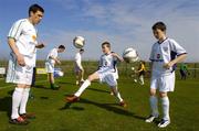 30 March 2005; Republic of Ireland and Liverpool star Steve Finnan, along with his team-mates, took time out from training to join local children to help launch the FAI Pepsi Summer Soccer Schools which takes place throughout the country in July and August.. Malahide FC, Malahide, Co. Dublin. Picture credit; Pat Murphy / SPORTSFILE