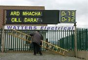 27 March 2005; The scoreboard attendant takes down his ladder after putting up the names of the teams before the start of the game. The score on the right is the final score of the preceding U-17 international rules game between Ireland and Australia. Allianz National Football League, Division 1B, Armagh v Kildare, St. Oliver Plunkett Park, Crossmaglen, Co. Armagh. Picture credit; Brendan Moran / SPORTSFILE