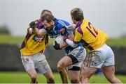 5 January 2014; Billy Sheehan, Laois, in action against Kevin O'Grady, left, and Ben Brosnan, Wexford. Bord na Mona O'Byrne Cup, Group A, Round 1, Wexford v Laois, Geraldine O’Hanrahans GAA Club, O'Kennedy Park, New Ross, Co. Wexford. Picture credit: Ray McManus / SPORTSFILE