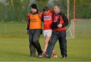 5 January 2014; Cork's Alan Sheehan is assisted off the pitch by selector Eoin Sexton, left, and physio Colin Lane, after picking up an injury. McGrath Cup, Quarter-Final, Cork v Limerick Institute of Technology, Mallow GAA Grounds, Mallow, Co. Cork. Picture credit: Diarmuid Greene / SPORTSFILE