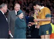 6 November 1999; John Eales, Australian captain, receives the Webb Ellis trophy from HRH Queen Elizabeth after his side defeated France. 1999 Rugby World Cup, Australia v France, Millennium Stadium, Cardiff, Wales. Picture credit: Brendan Moran / SPORTSFILE