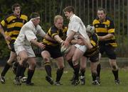 9 April 2005; Barry Kinsella, supported by team-mate Martin Garvey, Dublin University, is tackled by Maurice Logue, right, and Paul Deering, Co. Carlow. AIB All Ireland League 2004-2005, Division 1, Dublin University v Co. Carlow, College Park, Trinity College, Dublin. Picture credit; Brian Lawless / SPORTSFILE