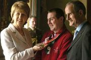 11 April 2005; Special Olympics Athlete Liam Weir, from Dungannon, Co. Tyrone, with President Mary McAleese and Dr. Martin McAleese at a reception, in Aras an Uachtarain, to celebrate the achievements of the Team Ireland at the 2005 Special Olympics World Winter Games, held recently in Japan. Aras an Uachtarain, Phoenix Park, Dublin. Picture credit; Ray McManus / SPORTSFILE