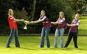 13 April 2005; Cork captain Juliet Murphy tries to pull the Ladies National Football League trophy from Galway's from left, Annette Clarke, captain, Maire O'Connell and Deirdre Heverin at a photocall ahead of the Suzuki Ladies National Football League Final. Merrion Square, Dublin. Picture credit; Pat Murphy / SPORTSFILE
