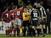 15 April 2005; Players from Shelbourne and St. Patrick's Athletic exchange words as linesman Martin Maloney attempts to keep the peace. eircom League, Premier Division, Shelbourne v St. Patrick's Athletic, Tolka Park, Dublin. Picture credit; Brian Lawless / SPORTSFILE