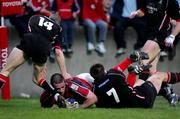 16 April 2005; Alan Quinlan, Munster, goes over for a try despite the attention of Allister Hogg and Chris Paterson, Edinburgh Rugby. Celtic League 2004-2005, Pool 1, Munster v Edinburgh Rugby, Thomond Park, Limerick. Picture credit; Kieran Clancy / SPORTSFILE