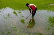 17 April 2005; 'Maor' Henry Kenny, from Roscommon, lends a hand with removing rain water from the pitch in advance of an inspection which resulted in the match being called off for Allianz National Football League Division 1 Semi-Final match between Mayo and Armagh at Dr. Hyde Park in Roscommon. Photo by Ray McManus/Sportsfile