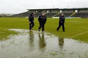 17 April 2005; Armagh manager Joe Kernan, team trainer John McCluskey, left, and County Secretary Paddy Og Nugent walk the pitch in advance of the match being called off. Allianz National Football League, Division 1 Semi-Final, Mayo v Armagh, Dr. Hyde Park, Roscommon. Picture credit; Ray McManus / SPORTSFILE