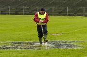 17 April 2005; 'Maor' Henry Kenny, from Roscommon, lends a hand with removing rain water from the pitch in advance of an inspection which resulted in the match being called off for Allianz National Football League Division 1 Semi-Final match between Mayo and Armagh at Dr. Hyde Park in Roscommon. Photo by Ray McManus/Sportsfile
