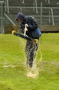 17 April 2005; James Hunt, from Roscommon, lends a hand with removing rain water from the pitch in advance of an inspection which resulted in the match being called off. Allianz National Football League, Division 1 Semi-Final, Mayo v Armagh, Dr. Hyde Park, Roscommon. Picture credit; Ray McManus / SPORTSFILE
