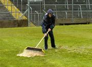 17 April 2005; James Hunt, from Roscommon, lends a hand with removing rain water from the pitch in advance of an inspection which resulted in the match being called off. Allianz National Football League, Division 1 Semi-Final, Mayo v Armagh, Dr. Hyde Park, Roscommon. Picture credit; Ray McManus / SPORTSFILE