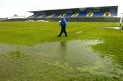 17 April 2005; Match referee Joe Murray inspects the pitch in advance of the match being called off. Suzuki Ladies National Football League Final, Galway v Cork, Dr. Hyde Park, Roscommon. Picture credit; Ray McManus / SPORTSFILE