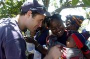 25 February 2005; Local women and children from Katoya greet Galway's Alan Kerins as bags of Mealie Meal arrive as part of the Presentation sisters Famine Relief project. Cheshire home for the physically challenged children, Mongu, Zambia. Picture credit; Damien Eagers / SPORTSFILE