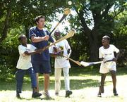 25 February 2005; Galway's Alan Kerins teaches some hurling to local children Mumbua, left, Namatimbo and Simona, right. Cheshire home for the physically challenged children, Mongu, Zambia. Picture credit; Damien Eagers / SPORTSFILE