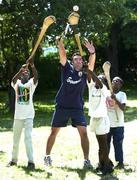25 February 2005; Galway's Alan Kerins plays hurling with local children Namatimbo, left, Simona and Mumbuwa right. Cheshire home for the physically challenged children, Mongu, Zambia. Picture credit; Damien Eagers / SPORTSFILE
