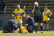 21 April 2005; Referee Fran Bolger phones for an ambulance after Nigel Dunne, Killina Presentation SS, received a serious injury. Leinster Vocational Schools Junior B Football Final, Colaiste Bhride, Carnew v Killina Presentation Secondary School, Geraldine Park, Athy, Co. Kildare. Picture credit; Damien Eagers / SPORTSFILE