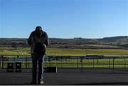 11 January 2014; A racegoer studies the form ahead of the day's races. Punchestown Racecourse, Punchestown, Co. Kildare. Picture credit: Ramsey Cardy / SPORTSFILE