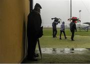 12 January 2014; Spectators take shelter in the match tunnel. Waterford Crystal Cup, Preliminary Round, Waterford v UL, WIT GAA Grounds, Carriganore, Co. Waterford. Picture credit: Ramsey Cardy / SPORTSFILE