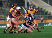 21 March 1999; David Kennedy of Tipperary in action against Ryan Quigley, left, Paul Codd, centre, and Rory McCarthy of Wexford during the Church and General National Hurling League Division 1B match between Tipperary and Wexford at Semple Stadium in Thurles, Tipperary. Photo by Ray McManus/Sportsfile