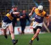 21 March 1999; Martin Storey, Wexford, in action against Eamon Corcoran, Tipperary. Tipperary v Wexford, National Hurling League, Division 1, Thurles. Picture credit; Damien Eagers/SPORTSFILE *** Local Caption *** 21 March 1999; Martin Storey of Wexford in action against Eamon Corcoran of Tipperary during the Church and General National Hurling League Division 1B match between Tipperary and Wexford at Semple Stadium in Thurles, Tipperary. Photo by Ray McManus/Sportsfile