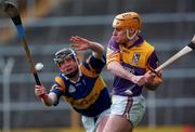 21 March 1999; Michael Jordan of Wexford in action against Eamon Corcoran of Tipperary during the Church and General National Hurling League Division 1B match between Tipperary and Wexford at Semple Stadium in Thurles, Tipperary. Photo by Ray McManus/Sportsfile
