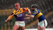 21 March 1999; Ryan Quigley of Wexford in action against Donnacha Fahy of Tipperary during the Church and General National Hurling League Division 1B match between Tipperary and Wexford at Semple Stadium in Thurles, Tipperary. Photo by Ray McManus/Sportsfile