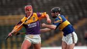 21 March 1999; Ryan Quigley of Wexford in action against Donnacha Fahy of Tipperary during the Church and General National Hurling League Division 1B match between Tipperary and Wexford at Semple Stadium in Thurles, Tipperary. Photo by Ray McManus/Sportsfile