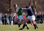 13 March 1999; Niall Moloney of Ireland is tackled by Adam Robertson of Scotland during the Shinty International match between Scotland and Ireland at Bught Park in Inverness, Scotland. Photo by Ray McManus/Sportsfile