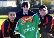 15 December 2004; Damien Thomson, aged 10, from Dublin, who was presented with a Bradford Bulls shirt by Bradford Bulls stars Paul Deacan, left, and Karl Paratt, which he designed for the team. Holy Rosary National School, Firhouse, Dublin. Picture credit; David Maher / SPORTSFILE