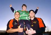 15 December 2004; Damien Thomson, aged 10, from Dublin, who was presented with a Bradford Bulls shirt by Bradford Bulls stars Paul Deacan, left, and Karl Paratt, which he designed for the team. Holy Rosary National School, Firhouse, Dublin. Picture credit; David Maher / SPORTSFILE