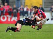 30 April 2005; Michael Blair, Edinburgh Rugby, is tackled by Rob Henderson, Munster. Celtic Cup 2004-2005, Quarter-Final, Munster v Edinburgh Rugby, Thomond Park, Limerick. Picture credit; Kieran Clancy / SPORTSFILE