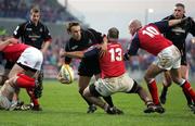 30 April 2005; Michael Blair, Edinburgh Rugby, is tackled by Mike Mullins and Paul Burke, 10, Munster. Celtic Cup 2004-2005, Quarter-Final, Munster v Edinburgh Rugby, Thomond Park, Limerick. Picture credit; Kieran Clancy / SPORTSFILE