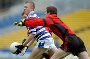 2 May 2005; Colm Doran, Knockbeg College, clears under pressure from  St. Mary's College players James Ruane, hidden, and Rory McCann. All-Ireland Colleges Senior 'A' Football Final, St. Mary's College v Knockbeg College, Semple Stadium, Thurles, Co. Tipperary. Picture credit; Ray McManus / SPORTSFILE