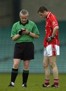 30 April 2005; Donal Og O'Donovan, Cork, is booked by referee Thomas Quigley. Cadbury's All-Ireland U21 Football Semi-Final, Cork v Galway, Gaelic Grounds, Limerick. Picture credit; Ray McManus / SPORTSFILE