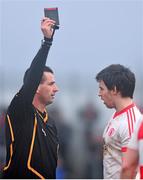 19 January 2014; Referee Shaun McLaughlin shows Mattie Donnelly, Tyrone, a black card. Power NI Dr. McKenna Cup, Semi-Final, Tyrone v Derry, Healy Park, Omagh, Co. Tyrone. Picture credit: Ramsey Cardy / SPORTSFILE