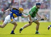 15 May 2005; The Limerick full-back Stephen lucey prepares to clear under pressure from Lar Corbett, Tipperary. Guinness Munster Senior Hurling Championship Quarter-Final, Tipperary v Limerick, Semple Stadium, Thurles, Co. Tipperary. Picture credit; David Levingstone / SPORTSFILE