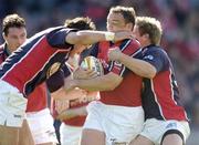 14 May 2005; Rob Henderson, Munster, is tackled by Mike Phillips, left, and Matthew Watkins, Llanelli Scarlets. Celtic Cup 2004-2005 Final, Munster v Llanelli Scarlets, Lansdowne Road, Dublin. Picture credit; Brendan Moran / SPORTSFILE