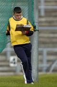 15 May 2005; A ballboy reads his programme during the match. Guinness Ulster Senior Hurling Championship, Down v London, Casement Park, Belfast. Picture credit; Brian Lawless / SPORTSFILE