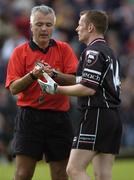 22 May 2005; Referee Seamus McGonigle about to show the yellow card to Sligo's Mark Breheny. Bank of Ireland Connacht Senior Football Championship, Leitrim v Sligo, O'Moore Park, Carrick-on-Shannon, Co. Leitrim. Picture credit; Damien Eagers / SPORTSFILE