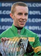 25 January 2014; Jockey Mark Walsh celebrates with the cup after winning the Boylesports.com Hurdle on Gilgamboa. Leopardstown Racecourse, Leopardstown, Co. Dublin. Picture credit: Ramsey Cardy / SPORTSFILE