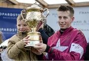 26 January 2014; Jockey Byan Cooper holds the winning trophy with Ted O'Leary, nephew of Michael O'Leary, CEO of Ryanair, after he rode Trifolium to victory in The Frank Ward Solicitors Arkle Novice Steeplechase. Leopardstown Racecourse, Leopardstown, Co. Dublin. Picture credit: Barry Cregg / SPORTSFILE