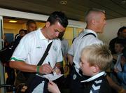 6 June 2005; Ian Harte, Republic of Ireland, signs his autograph for a local football supporter on his arrival at Vagar Airport, Faroe Islands, in advance of the Faroe Islands v Republic of Ireland game. Vagar Airport, Faroe Islands. Picture credit; David Maher / SPORTSFILE