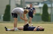 8 June 2005; Centre Gavin Duffy does some stretching exercises with athletic trainer Brian Green during training. Ireland rugby squad training, Kintetsu Hanazono rugby ground, Osaka, Japan. Picture credit; Brendan Moran / SPORTSFILE
