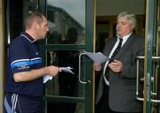 8 June 2005; Dublin hurling vice-captain Carl Meehan hands a letter to Eoin McKenna at the door of the Dublin County Board offices in Parnell Park, Dublin. Picture credit; Ray McManus/ SPORTSFILE