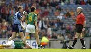 5 June 2005; Referee John Bannon prepares to issue Dublin's Ciaran Whealan, left, with a yellow card in the first minute of the game as Meath's Nigel Crawford lies injured on the ground and Anthony Moyles looks on. Bank of Ireland Leinster Senior Football Championship, Dublin v Meath, Croke Park, Dublin. Picture credit; David Maher / SPORTSFILE