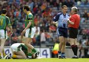 5 June 2005; Referee John Bannon prepares to issue Dublin's Ciaran Whealan with a yellow card in the first minute of the game as Meath's Nigel Crawford lies injured on the ground. Bank of Ireland Leinster Senior Football Championship, Dublin v Meath, Croke Park, Dublin. Picture credit; David Maher / SPORTSFILE