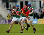 12 June 2005; Damien Roberts, Carlow, prepares to clear under pressure from Kevin Healy, left, and Adrian Freeman, Mayo. Christy Ring Cup, Group 2B, Round 2, Mayo v Carlow, Pearse Stadium, Galway. Picture credit; Ray McManus / SPORTSFILE