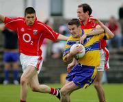 12 June 2005; Danny Lynch, Clare, in action against Michael Prout and Noel O'Riordan, Cork. Munster Junior Football Championship Semi-Final, Clare v Cork, Cusack Park, Ennis, Co. Clare. Picture credit; Kieran Clancy / SPORTSFILE